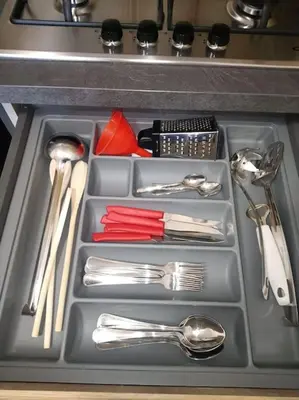 a tray with silver utensils in a sink at Mondello Ashur Margot House in Palermo