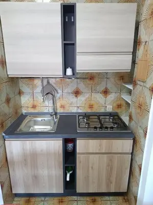 a kitchen with a sink and a stove at Mondello Ashur Margot House in Palermo