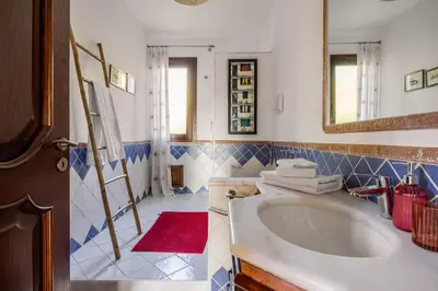 a bathroom with a large sink and a mirror at Cleo - Villa Siciliana in Partinico