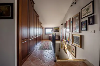 a hallway with a bunch of pictures on the wall at Cleo - Villa Siciliana in Partinico