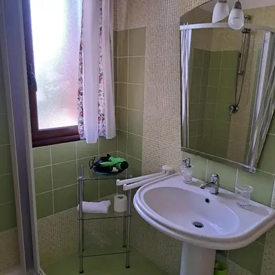 a bathroom with a sink and a mirror at PTA Appartavilla in Campofelice di Roccella