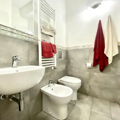 a bathroom with a white sink and a toilet at Appartamento Alexa in Castellammare del Golfo