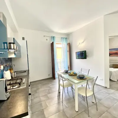 a kitchen with a table and chairs in a room at Appartamento Alexa in Castellammare del Golfo