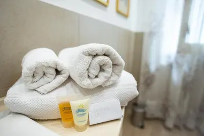 a pile of towels on a counter in a bathroom at Gardenia Home in Palermo