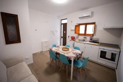 a kitchen and dining room with a table and chairs at Matilde’s Holiday House in Terrasini