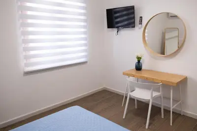 a room with a table and a mirror and a mirror at Matilde’s Holiday House in Terrasini