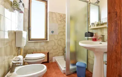a bathroom with a toilet and a sink at Awesome Home In Trappeto With Wifi in Trappeto