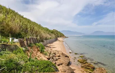 a beach with a retaining wall next to the ocean at Awesome Home In Trappeto With Wifi in Trappeto