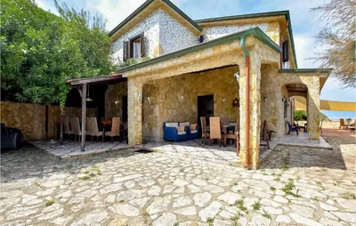 an external view of a house with a patio at Awesome Home In Trappeto With Wifi in Trappeto