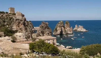 a group of boats in a body of water with rocks at Casa Diomeda in Scopello