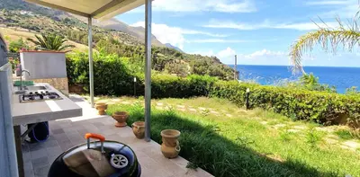 a kitchen with a view of the ocean at Casa Richilde in Scopello