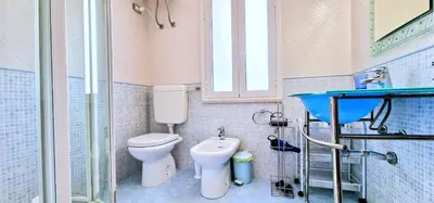 a bathroom with a toilet and a sink at Casa Richilde in Scopello
