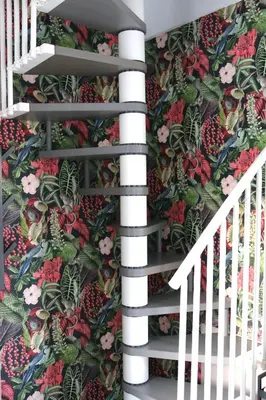a staircase with a floral wallpaper on the wall at 3B Mondello Apartments in Palermo