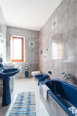 a bathroom with two blue sinks and a tub at Villa Duca Country House in Castellammare del Golfo