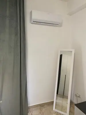 a bathroom with a mirror and a air conditioner at Cusumano house in Trappeto