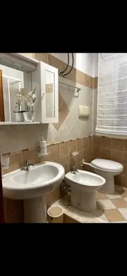 a bathroom with two sinks and a toilet at Cusumano house in Trappeto