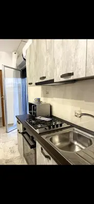 a kitchen with a sink and a stove top oven at Cusumano house in Trappeto