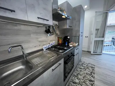 a small kitchen with a sink and a stove at Casa Il Tramonto by Holiday World in Balestrate