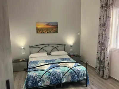 a bedroom with a bed and a painting on the wall at Casa Il Tramonto by Holiday World in Balestrate
