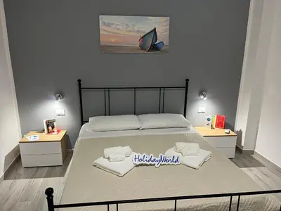 a bedroom with a large bed with two night stands at Casa Il Tramonto by Holiday World in Balestrate