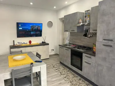 a kitchen with a table and a stove top oven at Casa Il Tramonto by Holiday World in Balestrate
