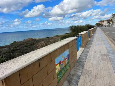 a walkway next to the ocean on a beach at Casa Il Tramonto by Holiday World in Balestrate