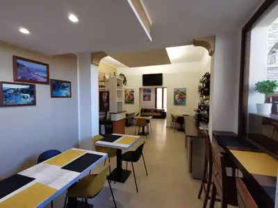 a restaurant with tables and chairs in a room at Il Giardino del Sol in San Vito lo Capo