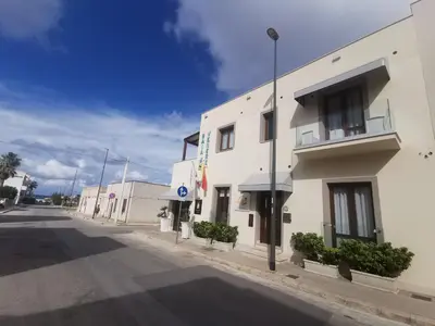 a white building on the side of a street at Il Giardino del Sol in San Vito lo Capo