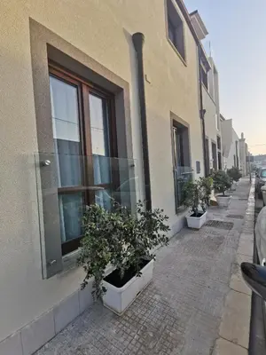 a row of potted plants on the side of a building at Il Giardino del Sol in San Vito lo Capo