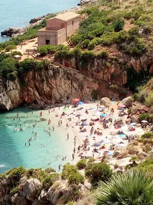 a group of people in the water at a beach at Il Giardino del Sol in San Vito lo Capo