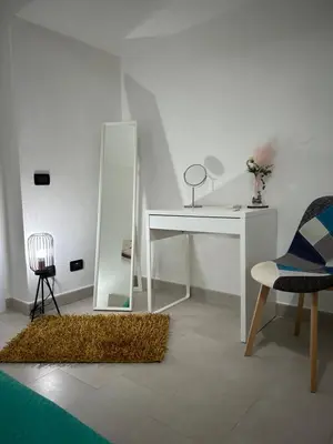 a room with a white desk and a mirror at Appartamento Olivuzza House in Palermo