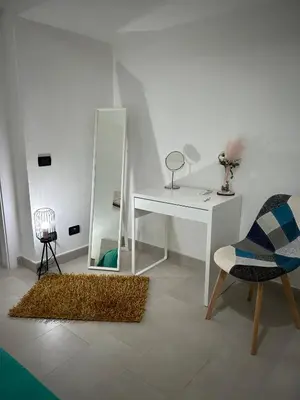 a room with a desk and a mirror and a chair at Appartamento Olivuzza House in Palermo