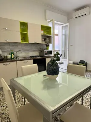 a kitchen with a table with a potted plant on it at STABILE APARTMENT in Palermo