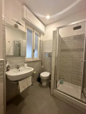 a bathroom with a sink and a toilet and a shower at STABILE APARTMENT in Palermo