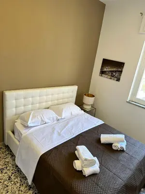 a bedroom with a bed with two towels on it at STABILE APARTMENT in Palermo