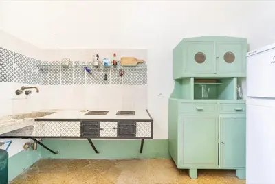 a kitchen with blue cabinets and a stove at Tonnara Foderà di Magazzinazzi in Alcamo