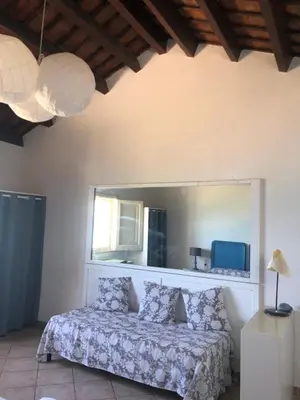 a bedroom with a bed and a large mirror at Tonnara Foderà di Magazzinazzi in Alcamo