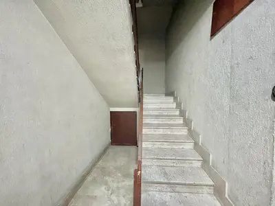 an empty hallway with stairs in an old building at La casetta di Alice in Palermo