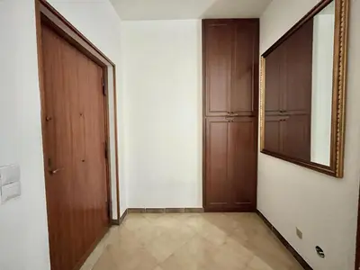 a hallway with two wooden doors and a mirror at La casetta di Alice in Palermo