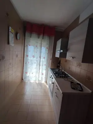 a small kitchen with a stove and a window at La casetta di Alice in Palermo