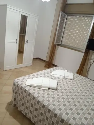 a bedroom with a bed with two towels on it at La casetta di Alice in Palermo