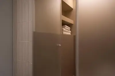 a bathroom with a closet with a mirror and towels at Aquacharme in Palermo
