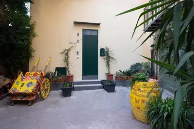 a building with a green door and some plants at Aquacharme in Palermo