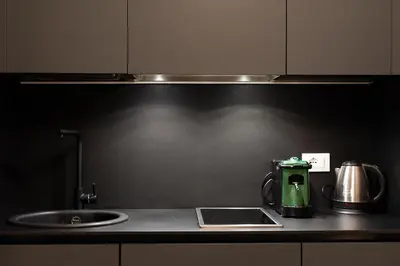 a kitchen counter with a green coffee maker and a sink at Aquacharme in Palermo