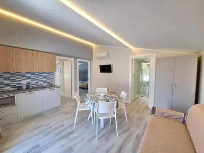 a kitchen and dining room with a table and chairs at Casa Vacanze Spiaggia Playa in Castellammare del Golfo