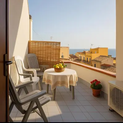 a balcony with a table and chairs and a view at SinyHouse in Terrasini