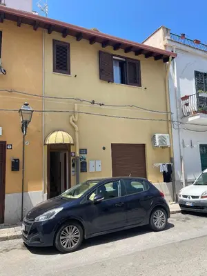 a black car parked in front of a building at SinyHouse in Terrasini