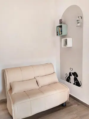 a couch in a living room with a wall at A casa di Mamma in Palermo