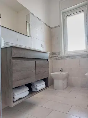 a bathroom with a sink and a toilet and a mirror at A casa di Mamma in Palermo