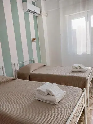 a room with two beds with towels on them at A casa di Mamma in Palermo
